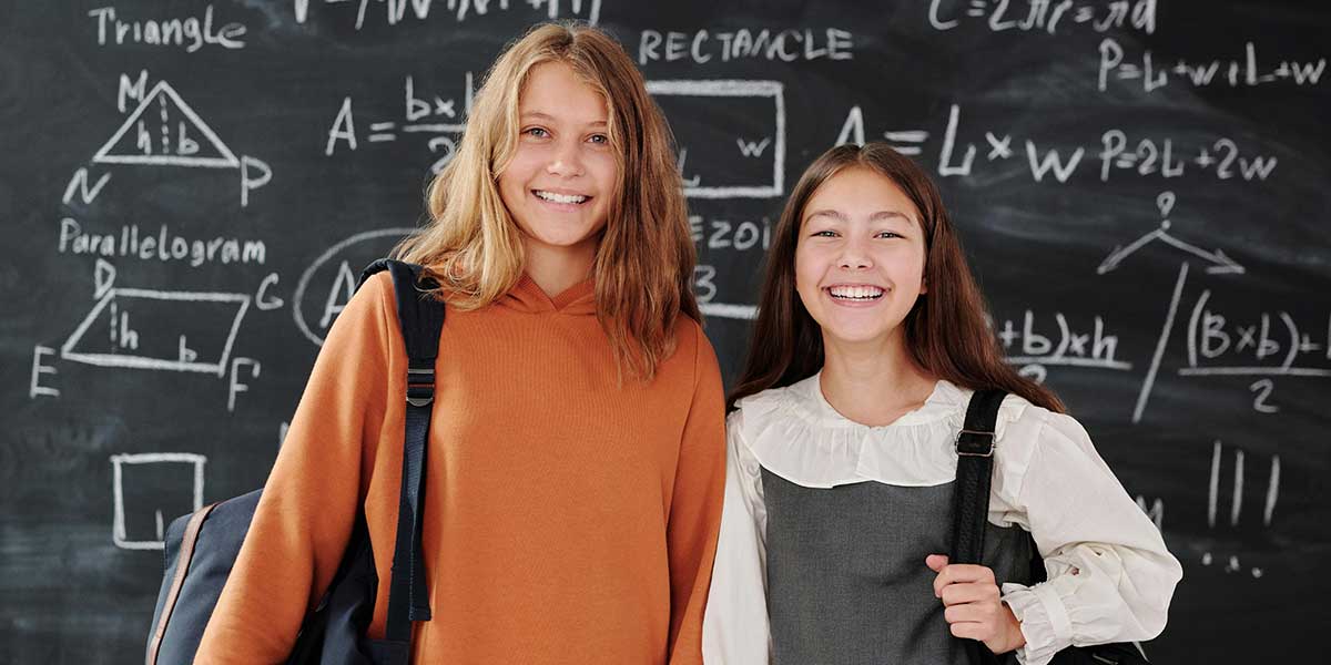 students standing in front of chalkboard