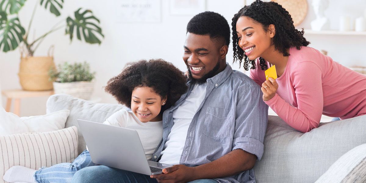 father and two daughters completing school applications