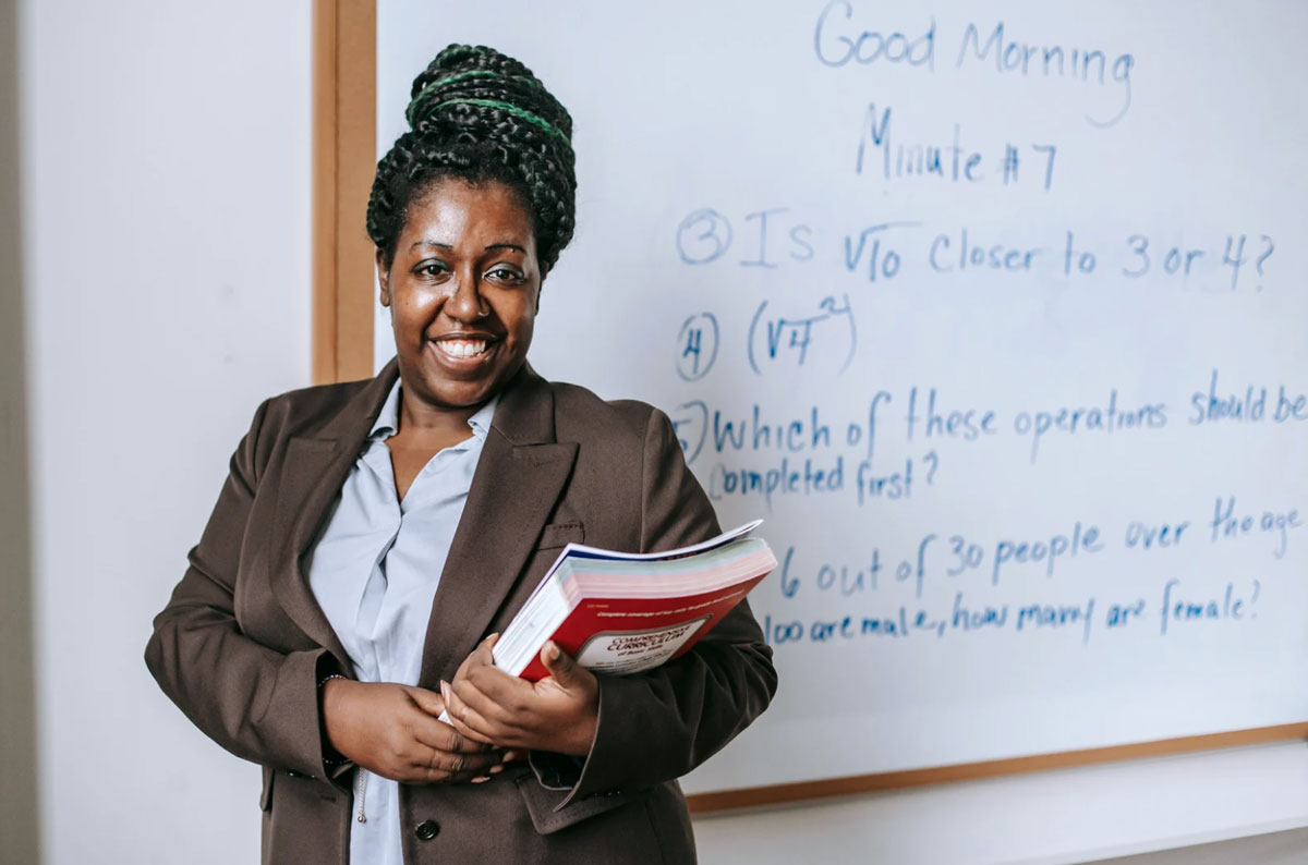 teacher-smiling-in-classroom teacher smiling in classroom